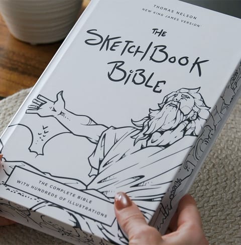 The Sketchbook Bible open to an illustrated page